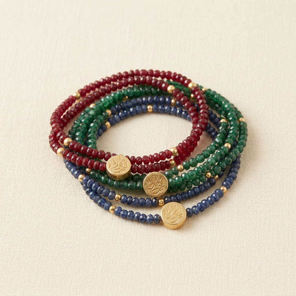 Ruby, emerald and sapphire wrap bracelets with gold calligraphy coins